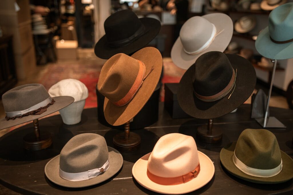 Assorted collection of stylish hats on display in a retail shop, showcasing variety and elegance.