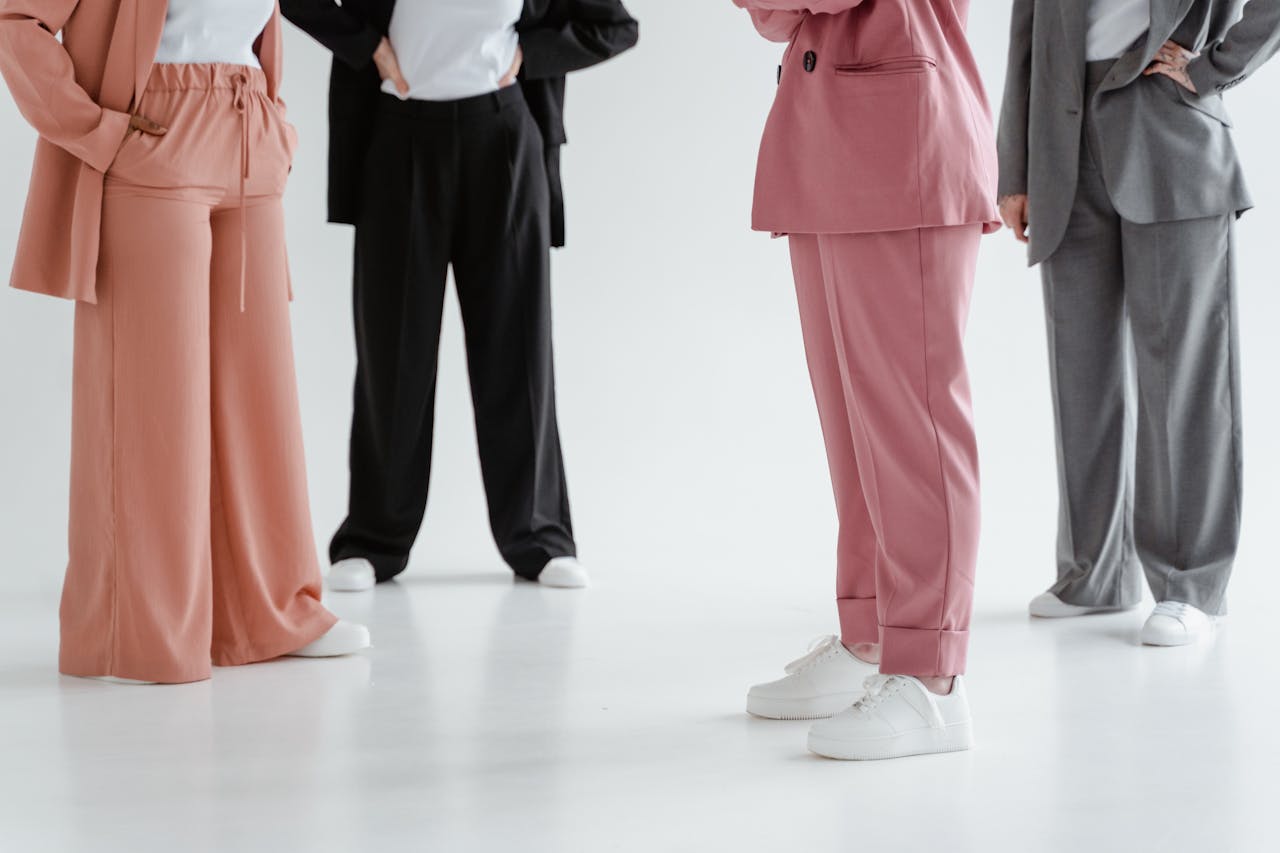 A group of people showcasing diverse corporate fashion styles in a modern studio environment.